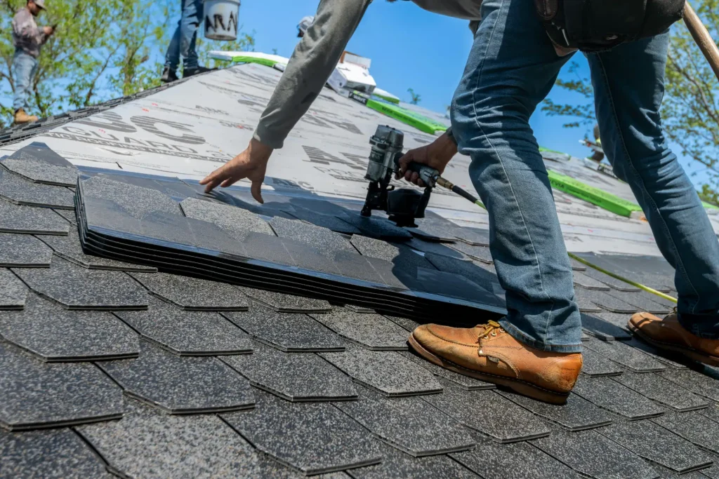 Contractor installing asphalt shingles during roof leak repairs in Highgate to prevent water damage and restore roof protection.